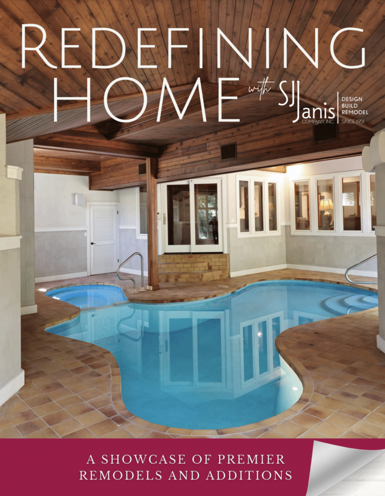 Indoor pool with tiled floors and wood-paneled ceiling, showcasing modern design. "Redefining Home" text highlights remodeling and additions services by S.J. Janis Company.